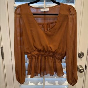 Very flattering long sleeve peplum sheer blouse.